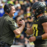 
              Oregon head coach Dan Lanning greets Oregon quarterback Bo Nix (10) after a touchdown against BYU during the first half of an NCAA college football game, Saturday, Sept. 17, 2022, in Eugene, Ore. (AP Photo/Andy Nelson)
            