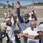 
              San Quentin State Prison inmates and a group of visiting players break a huddle after playing tennis together in San Quentin, Calif., Saturday, Aug. 13, 2022. (AP Photo/Godofredo A. Vásquez)
            
