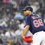 
              Boston Red Sox starting pitcher Brayan Bello (66) prepares to throw against a New York Yankees batter in the rain during the sixth inning of a baseball game Sunday, Sept. 25, 2022, in New York. (AP Photo/Jessie Alcheh)
            