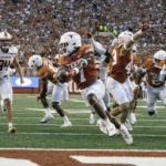 
              Texas running back Keilan Robinson (7) scores a touchdown after picking up the punt he blocked during an NCAA college football game against Louisiana-Monroe, Saturday, Sept. 3, 2022, in Austin, Texas. (AP Photo/Michael Thomas)
            