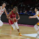 
              Puerto Rico's Arella Guirantes runs between China's Han Xu, left, and Wang Siyu, right, during their game at the women's Basketball World Cup in Sydney, Australia, Monday, Sept. 26, 2022. (AP Photo/Mark Baker)
            
