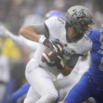 
              Colorado quarterback J.T. Shrout, front, is pursued by Air Force linebacker Bo Richter in the first half of an NCAA college football game Saturday, Sept. 10, 2022, at Air Force Academy, Colo. (AP Photo/David Zalubowski)
            
