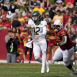 
              Baylor quarterback Blake Shapen (12) throws a pass ahead of Iowa State defensive lineman J.R. Singleton (56) during the second half of an NCAA college football game, Saturday, Sept. 24, 2022, in Ames, Iowa. Baylor won 31-24. (AP Photo/Charlie Neibergall)
            