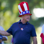 
              A fan watches Team USA during practice for the Presidents Cup golf tournament at the Quail Hollow Club, Wednesday, Sept. 21, 2022, in Charlotte, N.C. (AP Photo/Julio Cortez)
            