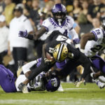 
              Colorado wide receiver Maurice Bell, front center, is pulled down after catching a pass, by TCU cornerback Josh Newton and safeties Abraham Camara and Millard Bradford, from left, during the first half of an NCAA college football game Friday, Sept. 2, 2022, in Boulder, Colo. (AP Photo/David Zalubowski)
            