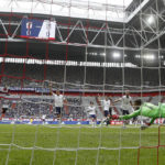 
              Japan's Daichi Kamada, right, scores the opening goal against United States goalkeeper Matt Turner during the international friendly soccer match between USA and Japan as part of the Kirin Challenge Cup in Duesseldorf, Germany, Friday, Sept. 23, 2022. (AP Photo/Martin Meissner)
            