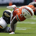 
              Southern Miss defensive back Brendan Toles takes down Miami running back Henry Parrish Jr. during the first half of an NCAA college football game, Saturday, Sept. 10, 2022, in Miami Gardens, Fla. (AP Photo/Wilfredo Lee)
            