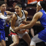 
              Connecticut Sun's Natisha Hiedeman, left, and Brionna Jones, right, pressure Las Vegas Aces' Kelsey Plum during the first half in Game 3 of basketball's WNBA Finals on Thursday, Sept. 15, 2022, in Uncasville, Conn. (AP Photo/Jessica Hill)
            