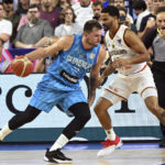 
              Germany's Nick Weiler-Babb and Slovenia's Luka Doncic, left, fight for the ball during the Eurobasket preliminary round Group B match between Germany and Slovenia in Cologne, Germany, Tuesday, Sept. 6, 2022. (Federico Gambarini/dpa via AP)
            