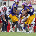 
              East Carolina's Ryan Jones (4) tries to break a tackle by North Carolina State's Savion Jackson (9) during the second half of an NCAA college football game in Greenville, N.C., Saturday, Sept. 3, 2022. (AP Photo/Karl B DeBlaker)
            