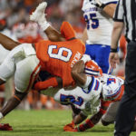 
              Clemson safety R.J. Mickens (9) tackles Louisiana Tech running back Charvis Thornton (22) during the first half of an NCAA college football game Saturday, Sept. 17, 2022, in Clemson, S.C. (AP Photo/Jacob Kupferman)
            