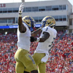 
              Tulsa wide receivers Keylon Stokes (2) and Isaiah Epps (3) celebrate after a touchdown by Epps during the first half of an NCAA college football game against Mississippi in Oxford, Miss., Saturday, Sept. 24, 2022. (AP Photo/Thomas Graning)
            
