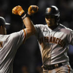 
              San Francisco Giants' Thairo Estrada, right, celebrates with teammate Austin Dean (1) after hitting a solo home run during the seventh inning of a baseball game against the Chicago Cubs Sunday, Sept. 11, 2022, in Chicago. (AP Photo/Paul Beaty)
            
