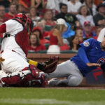 
              Chicago Cubs' Nick Madrigal, right, is tagged out at home by St. Louis Cardinals catcher Yadier Molina during the first inning of a baseball game Friday, Sept. 2, 2022, in St. Louis. (AP Photo/Jeff Roberson)
            