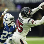 
              Houston Texans wide receiver Chris Moore (15) hauls in a pass as Indianapolis Colts cornerback Kenny Moore II (23) defends during the second half of an NFL football game Sunday, Sept. 11, 2022, in Houston. (AP Photo/David J. Phillip)
            