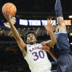 
              FILE - Then-Kansas guard Ochai Agbaji (30) shoots around Villanova forward Eric Dixon during the second half of a college basketball game in the semifinal round of the Men's Final Four NCAA tournament, Saturday, April 2, 2022, in New Orleans. Cleveland made its acquisition of All-Star guard Donovan Mitchell in a trade with Utah official on Saturday, Sept. 3. Cleveland sent guard Collin Sexton, guard Lauri Markkanen and rookie guard Ochai Agbaji to Utah along with unprotected first-round draft picks in 2025, 2027 and 2029. (AP Photo/David J. Phillip, File)
            