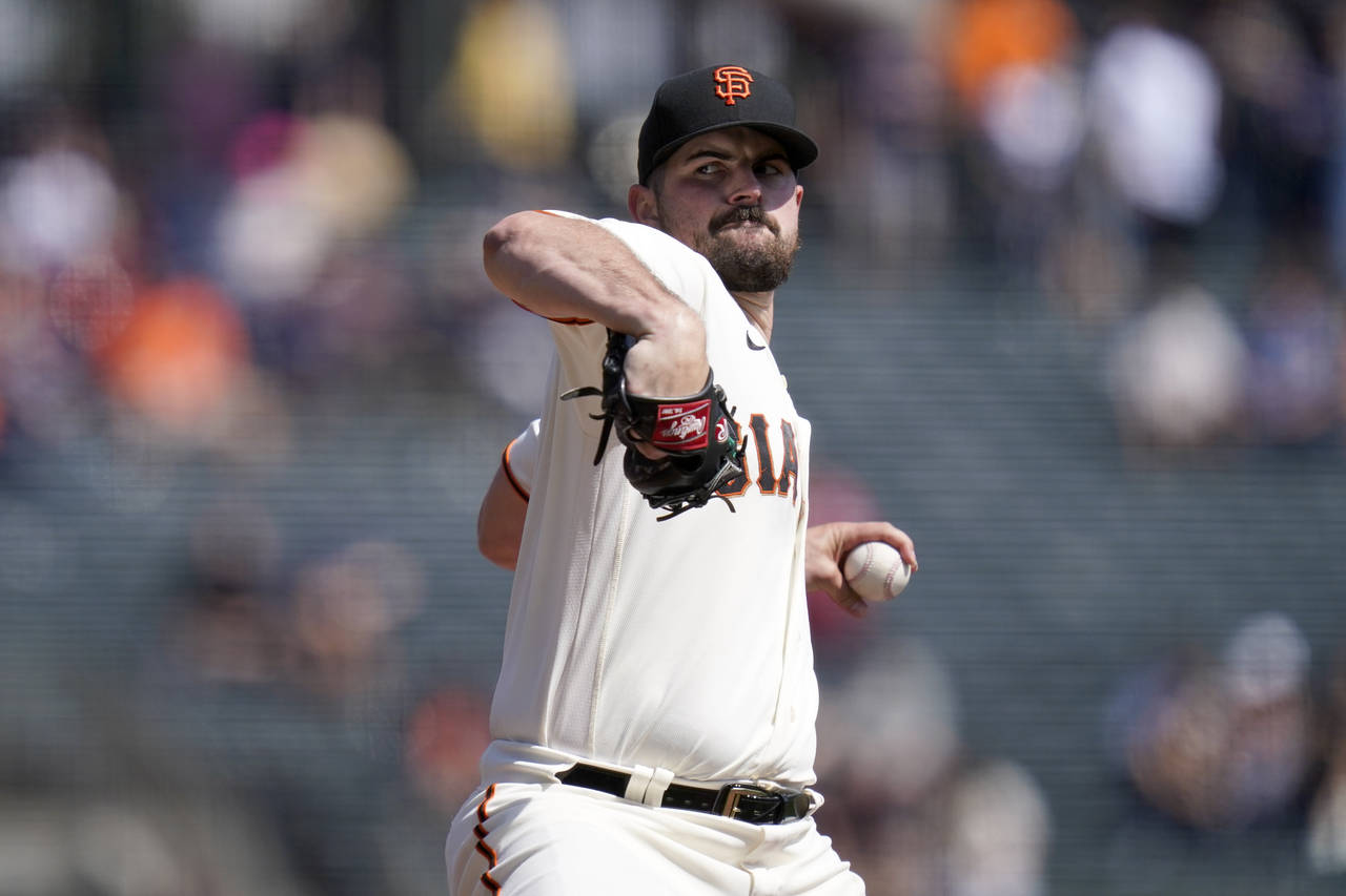 San Francisco Giants' Carlos Rodón pitches against the Atlanta Braves during the first inning of a...