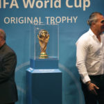 
              FILE - Iran's Football Federation President Mehdi Taj, left, and former Iran's national soccer team captain Ahmad Reza Abedzadeh stand next to the FIFA World Cup trophy after being revealed during the Trophy Tour, at Milad Tower hall in Tehran, Iran, Thursday, Sept. 1, 2022. German top division soccer club Hoffenheim is skipping this year's World Cup in Qatar. The club says on Thursday, Sept. 22, 2022, that it will not give any coverage to this year’s World Cup. (AP Photo/Vahid Salemi, File)
            