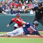 
              Minnesota Twins' José Miranda (64) slides safely into third base as Cleveland Guardians third baseman Cleveland Guardians' Tyler Freeman (2) applies the tag during the fourth inning of a baseball game, Monday, Sept. 19, 2022, in Cleveland. (AP Photo/Nick Cammett)
            