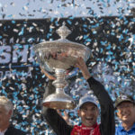 
              Team Penske driver Will Power, of Australia, holds up the championship trophy after winning the championship after the IndyCar season finale auto race at Laguna Seca Raceway on Sunday, Sept. 11, 2022, Monterey, Calif. (AP Photo/Nic Coury)
            