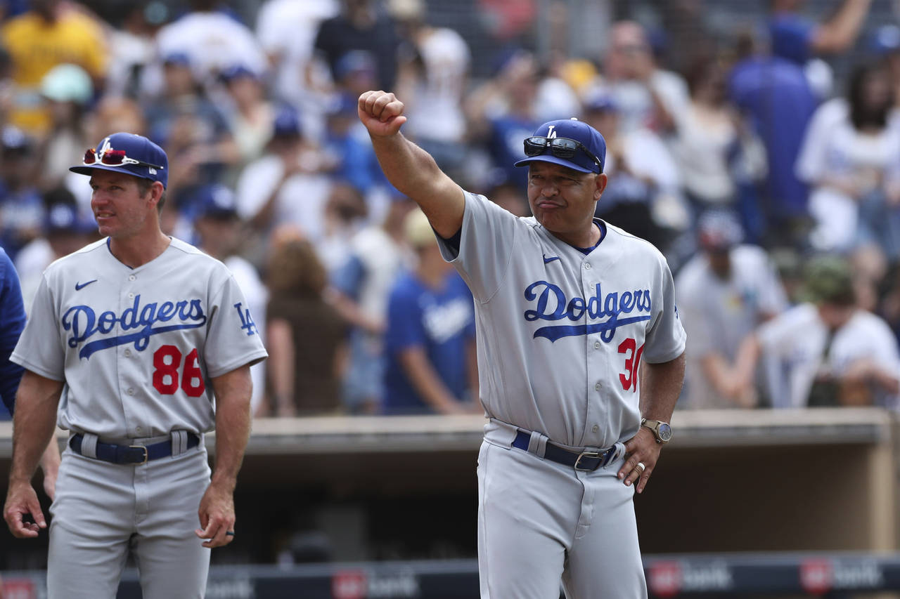 Los Angeles Dodgers manager Dave Roberts gestures to the crowd after the team defeated the San Dieg...