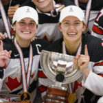 
              Canada's Marie-Philip Poulin, left, and Brianne Jenner, center, hold the trophy after The IIHF World Championship Woman's ice hockey gold medal match between USA and Canada in Herning, Denmark, Sunday, Sept. 4, 2022. (Bo Amstrup/Ritzau Scanpix via AP)
            