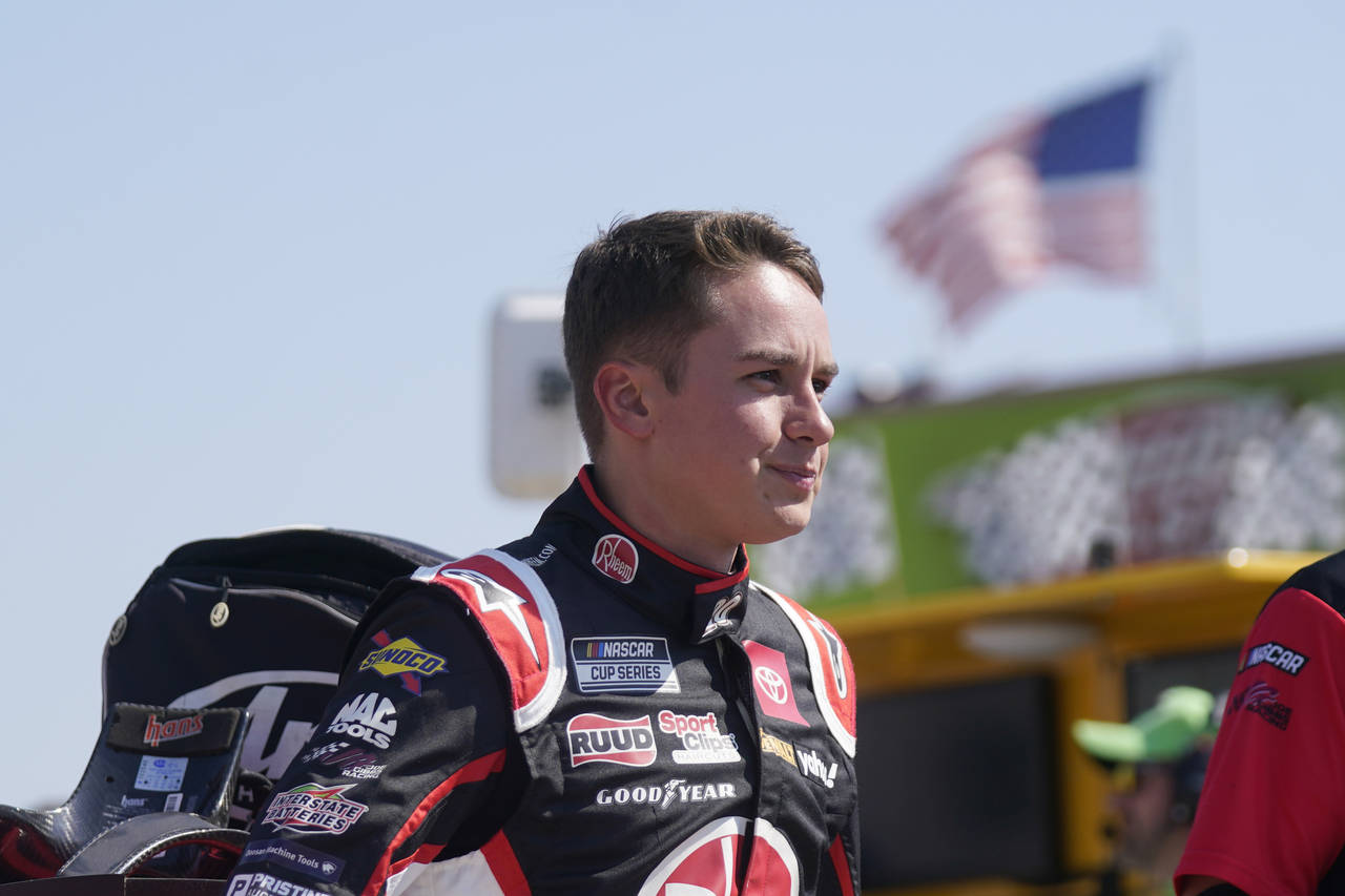 Christopher Bell prepares stands next to his car before practice for the NASCAR Cup Series auto rac...
