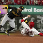 
              St. Louis Cardinals' Dylan Carlson (3) is tagged out by Pittsburgh Pirates second baseman Rodolfo Castro (14) on a failed stolen base attempt during the second inning of a baseball game Friday, Sept. 30, 2022, in St. Louis. (AP Photo/Jeff Roberson)
            