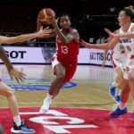 
              Canada's Shay Colley, centre, runs at France's Alexia Chartereau, right, and France's Lisa Berkani, left, during their game at the women's Basketball World Cup in Sydney, Australia, Friday, Sept. 23, 2022. (AP Photo/Mark Baker)
            