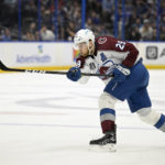 
              FILE - Colorado Avalanche center Nathan MacKinnon (29) attempts a shot during the second period of Game 3 of the NHL hockey Stanley Cup Finals against the Tampa Bay Lightning on Monday, June 20, 2022, in Tampa, Fla. The Colorado Avalanche are making Nathan MacKinnon the highest-paid player in the NHL’s salary cap era. MacKinnon, who just turned 27 earlier this month, signed an eight-year contract that is worth $100.8 million, according to a person with knowledge of the situation. The person spoke to The Associated Press on condition of anonymity Tuesday, Sept. 20, 2022, because the team did not announce terms of the contract. (AP Photo/Phelan M. Ebenhack, File)
            