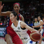 
              United States' A'ja Wilson, left, attempts to block South Korea's Park Hyejin during their game at the women's Basketball World Cup in Sydney, Australia, Monday, Sept. 26, 2022. (AP Photo/Mark Baker)
            