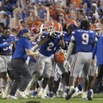 
              Florida linebacker Amari Burney (2) is swarmed by teammates on the sideline after making a game-saving interception in the end zone near the end of an NCAA college football game against Utah, Saturday, Sept. 3, 2022, in Gainesville, Fla. (AP Photo/Phelan M. Ebenhack)
            