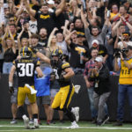 
              Iowa defensive back Cooper DeJean (3) celebrates with teammate defensive back Quinn Schulte (30) after intercepting a pass during the first half of an NCAA college football game against Iowa State, Saturday, Sept. 10, 2022, in Iowa City, Iowa. (AP Photo/Charlie Neibergall)
            