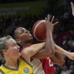 
              Canada's Nirra Fields, right, and Australia's Kristy Wallace get tangled during their bronze medal game at the women's Basketball World Cup in Sydney, Australia, Saturday, Oct. 1, 2022. (AP Photo/Rick Rycroft)
            