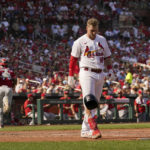 
              Cincinnati Reds catcher Chuckie Robinson, left, jogs off the field as St. Louis Cardinals' Nolan Gorman, right, throws down his helmet after striking out to end the seventh inning of a baseball game Sunday, Sept. 18, 2022, in St. Louis. (AP Photo/Jeff Roberson)
            