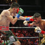
              FILE - Leo Santa Cruz, left, lands a punch on Abner Mares during the 10th round of their WBC diamond featherweight and WBA featherweight championship boxing bout, Saturday, Aug. 29, 2015, in Los Angeles. Mares isn't returning to the ring Sunday night after a four-year absence because of pride or financial necessity. The 36-year-old former three-division world champion and current Showtime boxing commentator says he simply missed the thrill of competition, even after a nasty scare from a detached retina before the coronavirus pandemic. (AP Photo/Danny Moloshok, FILE)
            