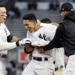 
              New York Yankees' Oswaldo Cabrera is congratulated by teammates after he drove in the winning run with a single during the 12th inning against the Minnesota Twins in the first baseball game of a doubleheader Wednesday, Sept. 7, 2022, in New York. The Yankees won 5-4. (AP Photo/Adam Hunger)
            
