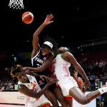 
              France's Mamignan Toure collides with Mali's Kankou Coulibaly, left, and Alima Dembele, right, as she attempts a shot at goalduring their game at the women's Basketball World Cup in Sydney, Australia, Sunday, Sept. 25, 2022. (AP Photo/Mark Baker)
            