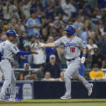 
              Los Angeles Dodgers' Will Smith (16) celebrates with third base coach Dino Ebel after hitting a home run during the eighth inning of the team's baseball game against the San Diego Padres, Thursday, Sept. 29, 2022, in San Diego. (AP Photo/Gregory Bull)
            