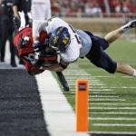 
              Murray State's Andrew Long (56) tackles Texas Tech's Tahj Brooks (28) during the first half of an NCAA college football game Saturday, Sept. 3, 2022, in Lubbock, Texas. (AP Photo/Brad Tollefson)
            