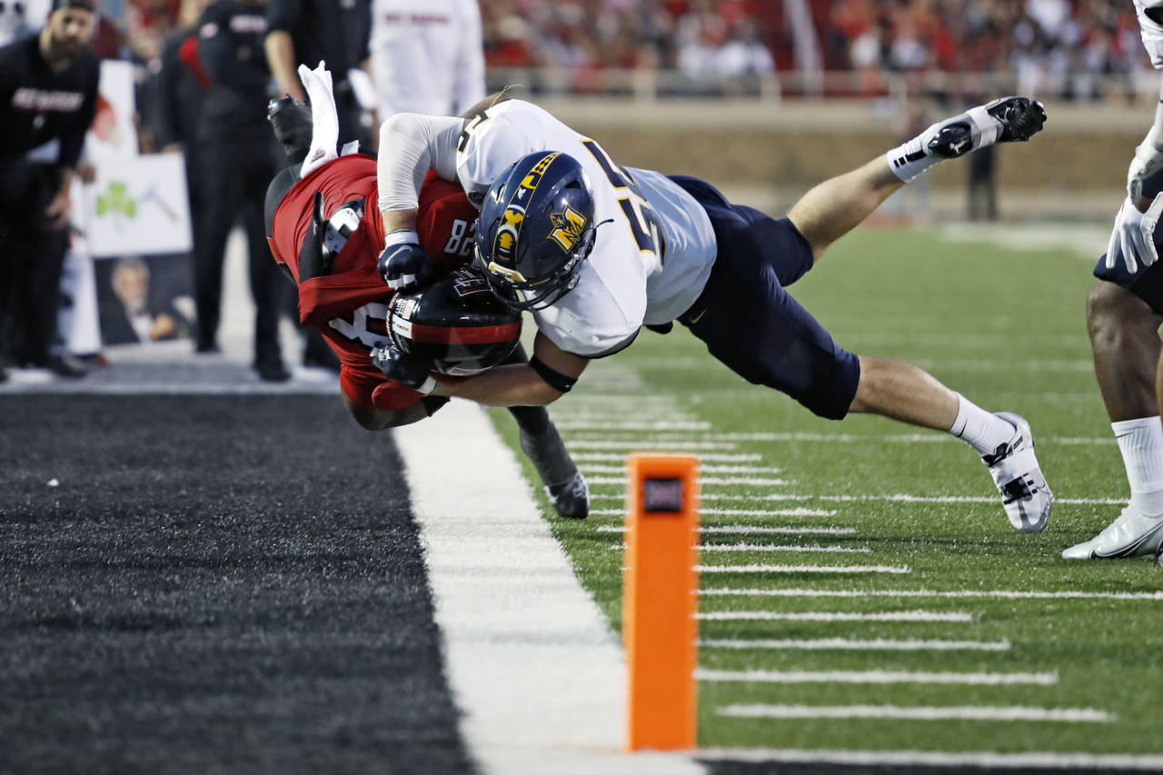 Murray State's Andrew Long (56) tackles Texas Tech's Tahj Brooks (28) during the first half of an N...