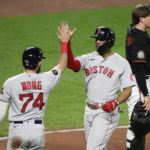 
              Boston Red Sox's Xander Bogaerts, center, celebrates his two-run home run with Connor Wong (74) during the third inning of a baseball game against the Baltimore Orioles, Friday, Sept. 9, 2022, in Baltimore. Orioles catcher Adley Rutschman, right, looks on. (AP Photo/Nick Wass)
            