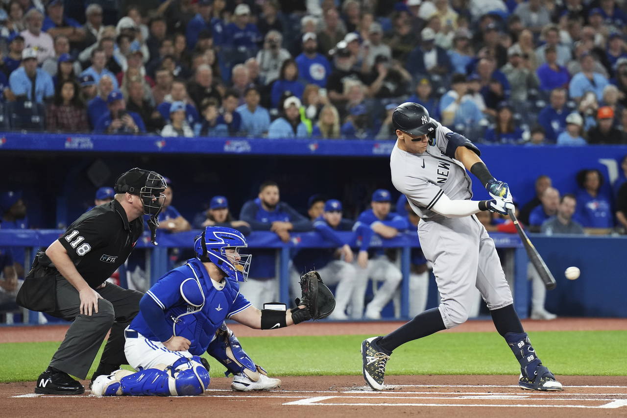 New York Yankees' Aaron Judge lines out to third as Toronto Blue Jays catcher Alejandro Kirk watche...