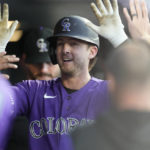 
              Colorado Rockies' Ryan McMahon is congratulated as he returns to the dugout after hitting a solo home run off San Diego Padres starting pitcher Yu Darvish to lead off the bottom of the first inning of a baseball game Saturday, Sept. 24, 2022, in Denver. (AP Photo/David Zalubowski)
            