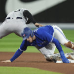 
              Toronto Blue Jays' Danny Jansen, right, is ruled safe at second base against New York Yankees second baseman Gleyber Torres, left, after a review during seventh-inning baseball game action in Toronto, Monday, Sept. 26, 2022. (Nathan Denette/The Canadian Press via AP)
            