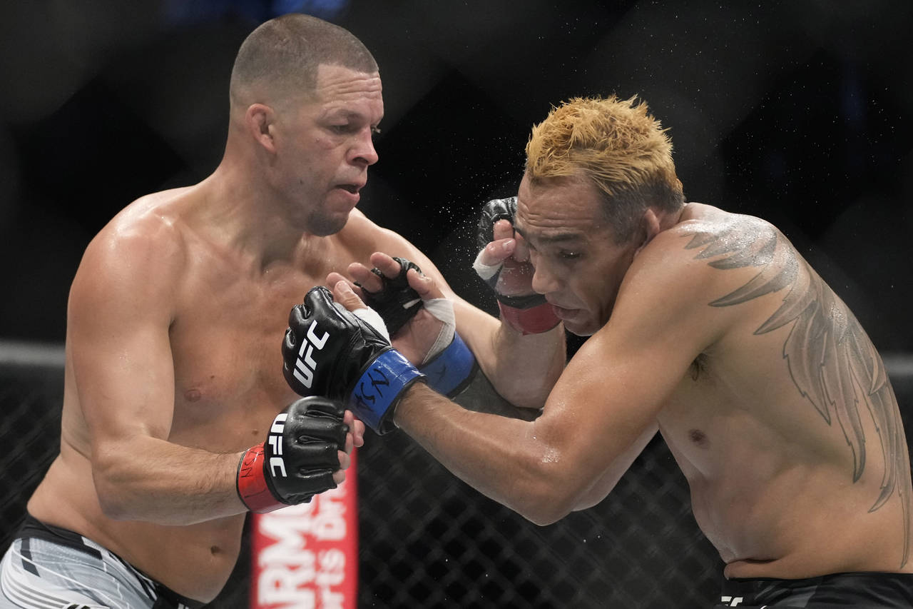 Nate Diaz hits Tony Ferguson in a welterweight bout during the UFC 279 mixed martial arts event Sat...