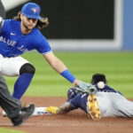 
              Tampa Bay Rays' Randy Arozarena steals second base ahead of the tag from Toronto Blue Jays shortstop Bo Bichette during the third inning of the second baseball game of a doubleheader Tuesday, Sept. 13, 2022, in Toronto. (Frank Gunn/The Canadian Press via AP)
            