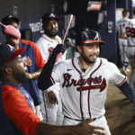 
              Atlanta Braves' Travis d'Arnaud, right, chops the pink swords with outfielder Guillermo Heredia, left, in the dugout after hitting a two-run home run against the Washington Nationals during the fourth inning of a baseball game Tuesday, Sept. 20, 2022, in Atlanta. (Curtis Compton/Atlanta Journal-Constitution via AP)
            