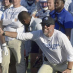 
              Indiana State NCAA college football head coach Curt Mallory signals to his offense during the Sycamores' overtime win against North Alabama on Sept. 1, 2022, in Terre Haute, Ind. Mallory, a former Michigan player who followed his father and brothers into coaching and has spent three decades in the profession, had never before been awoken by the dreaded pre-dawn knock on the door. On Aug. 21, he opened it to find athletic director Sherrard Clinkscales on the other side. (Joseph C. Garza/The Tribune-Star via AP)
            