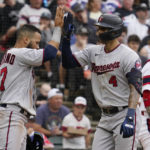 
              Minnesota Twins' Carlos Correa, right, celebrates with Gilberto Celestino after hitting a two-run home run during the fifth inning of a baseball game against the Chicago White Sox in Chicago, Sunday, Sept. 4, 2022. (AP Photo/Nam Y. Huh)
            